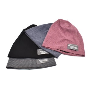 Winter knitted slouchy beanie hats with rib-knit texture and woven labels in four colors