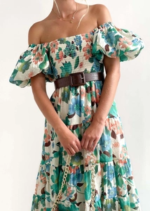Detailed close-up of elastic smocked bodice and puff sleeves on floral maxi dress