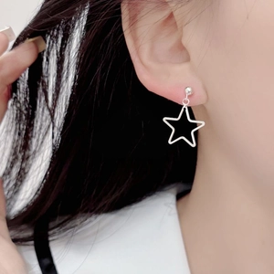 Minimalist S925 sterling silver hollow star stud earrings worn on female ear