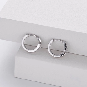Minimalist 925 sterling silver geometric huggie hoop earrings on white blocks