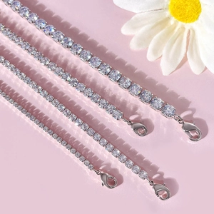 Silver tennis necklaces with zircon stones in various sizes on a pink background