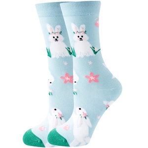 Close-up of light blue cotton socks with floral rabbit pattern and green heel accents