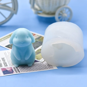 Detail of 3D lop-eared rabbit silicone mold with a finished blue resin bunny model