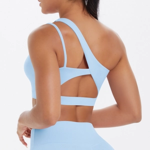 Macro view of blue asymmetric single-shoulder yoga bra with criss-cross back straps