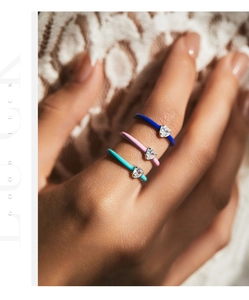 Close-up of S925 silver ring set with colorful enamel and heart-shaped zircon stones