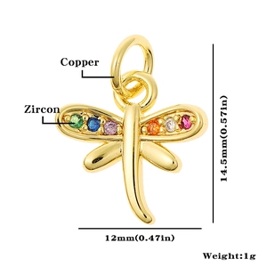 Detailed view of tiny golden dragonfly pendant with colorful zircons and size markings