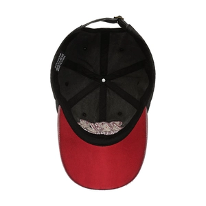 Interior view of vintage cotton baseball cap featuring red brim and metal buckle