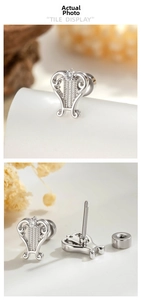 Detailed view of silver lyre stud earrings with screw back design and small zirconia