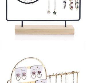 Detail showing black and gold metal earring organizers with solid wood bases