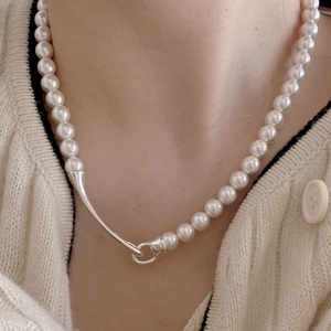 Detail of 925 sterling silver pearl necklace with unique irregular silver metal clasp