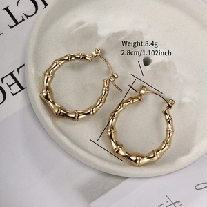 Detail of gold bamboo hoop earring with 2.8cm diameter shown on a display tray