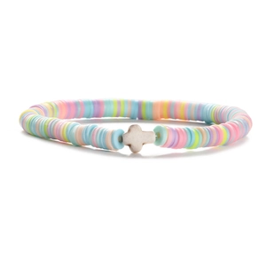 Detail shot of colorful 6mm heishi clay beads and a white cross bead on a white background