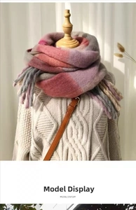 Detail of soft rainbow plaid knit scarf with long fringe on a beige knitted sweater