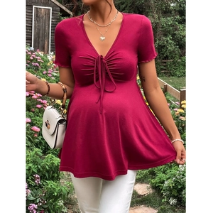 Close-up of rose red maternity dress with V-neckline and drawstring pleat detail
