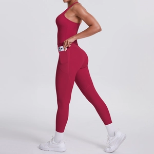 Macro detail of high-waist yoga pants side pocket with phone storage in burgundy set
