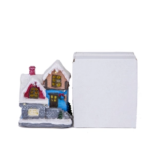Christmas glowing house ornament shown next to its white protective packaging box