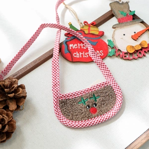 Detail of Christmas dog bandana with red plaid strap and plush reindeer embroidery