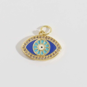 Macro shot of 18K gold plated evil eye pendant with blue enamel and zircon inlay