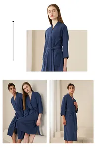 Detail of dark blue waffle robe showing texture, long sleeves, and tie waist