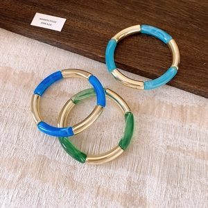 Three-piece acrylic resin bracelets in blue and green with gold metal accents