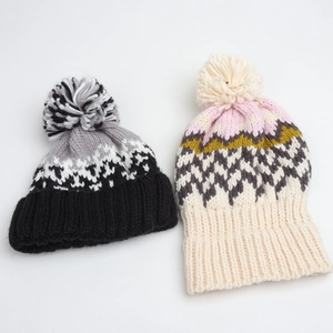 Winter geometric knit beanies with pom-poms in colorful diamond patterns for warmth