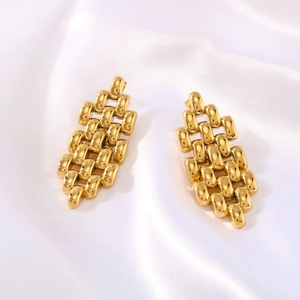 Detailed view of gold geometric mesh chain earrings on soft white silk fabric