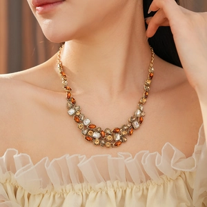 Detailed view of vintage gold statement necklace with amber and champagne crystals