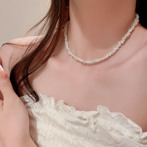 Close-up of elegant candy-colored beaded necklace with twisted chain design on model
