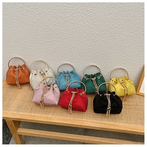 Macro shot of colorful rhinestone bucket bags with gold handles and drawstring details
