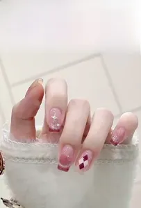 Detail of French cat eye press-on nails with wine red gradient and star glitter patterns