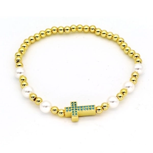 Golden bead bracelet featuring white pearls and a blue zircon cross pendant for women
