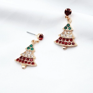 Detail view of gold Christmas tree stud earrings with colorful crystals on silk