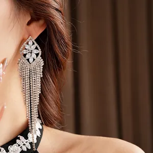 Elegant silver tassel earrings with zircon rhombic flower design shown on model