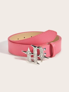 Close-up of pink leather belt featuring a silver rhinestone-studded star buckle