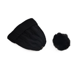 Detail of black cable knit beanie with detachable faux fur pom-pom and metal snap