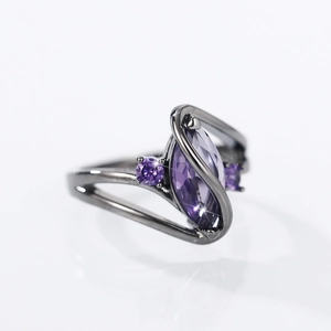 Macro side view of marquise-cut purple zircon stone set in gunmetal plating on fashion ring