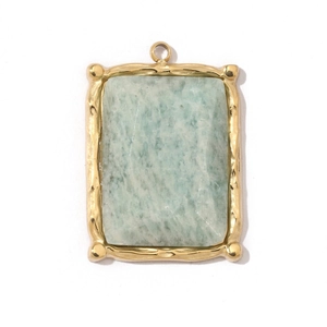 Macro shot of rectangular gold stainless steel pendant with green amazonite stone inlay