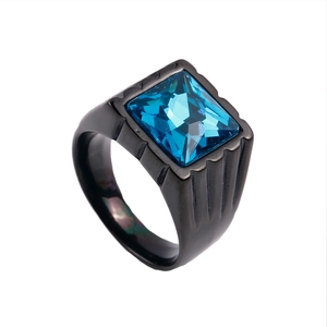 Detail of square blue gemstone set in a titanium steel ring with grooved band