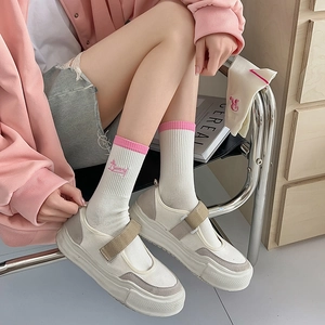 Detailed embroidery of pink Bunny text on ribbed cotton mid-calf socks for women