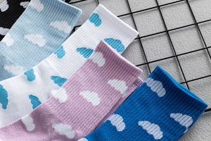 Detail of knit socks featuring cute cloud patterns and ribbed cuffs in various colors