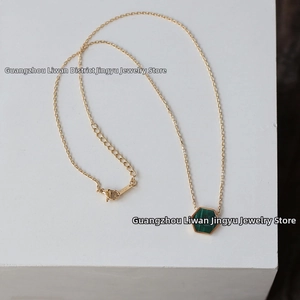 Detail of 18K gold honeycomb necklace featuring a green malachite bee pendant