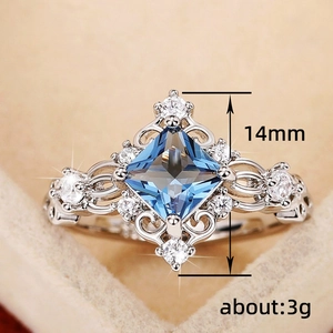 Elegant princess blue gemstone ring with hollow silver patterns and zircon accents