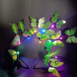 Detail showing green butterfly headbands with glowing colorful LED lights on black metal frame