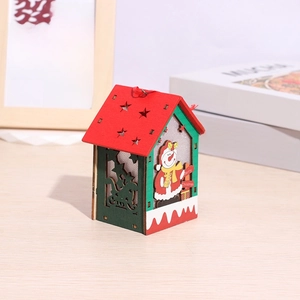 Close-up of wooden Christmas house ornament with LED light, snowman and star cutouts