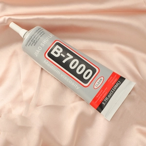 Detail of B7000 glue precision tip on pink satin for jewelry DIY and phone repair
