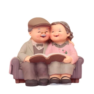 Elderly couple sitting on sofa reading a book resin figurine decoration for car or cake