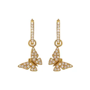 Macro detail of butterfly earrings with white zircon inlays and precise measurements