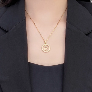 Close-up of 18K gold plated snake pendant necklace with zircon stones on a model