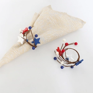 Detail of red white and blue star napkin ring on a patterned napkin for July 4th decor