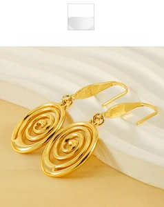 Macro detail of gold plated spiral geometric earrings showing the 316 stainless steel mark